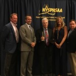 Susan Reid Dullea presents the NYSPHSAA Hall of Fame award to former Ardsley Athletic Director Hank Roth in July 2017