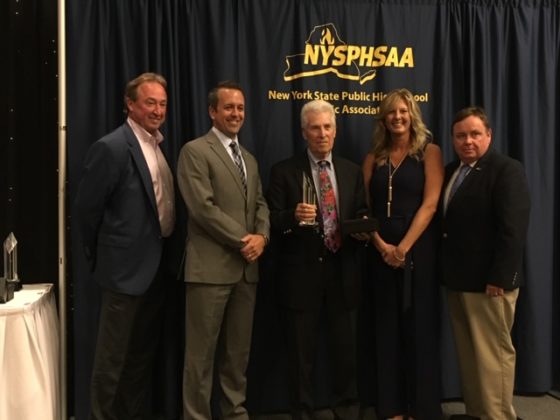 Susan Reid Dullea presents the NYSPHSAA Hall of Fame award to former Ardsley Athletic Director Hank Roth in July 2017