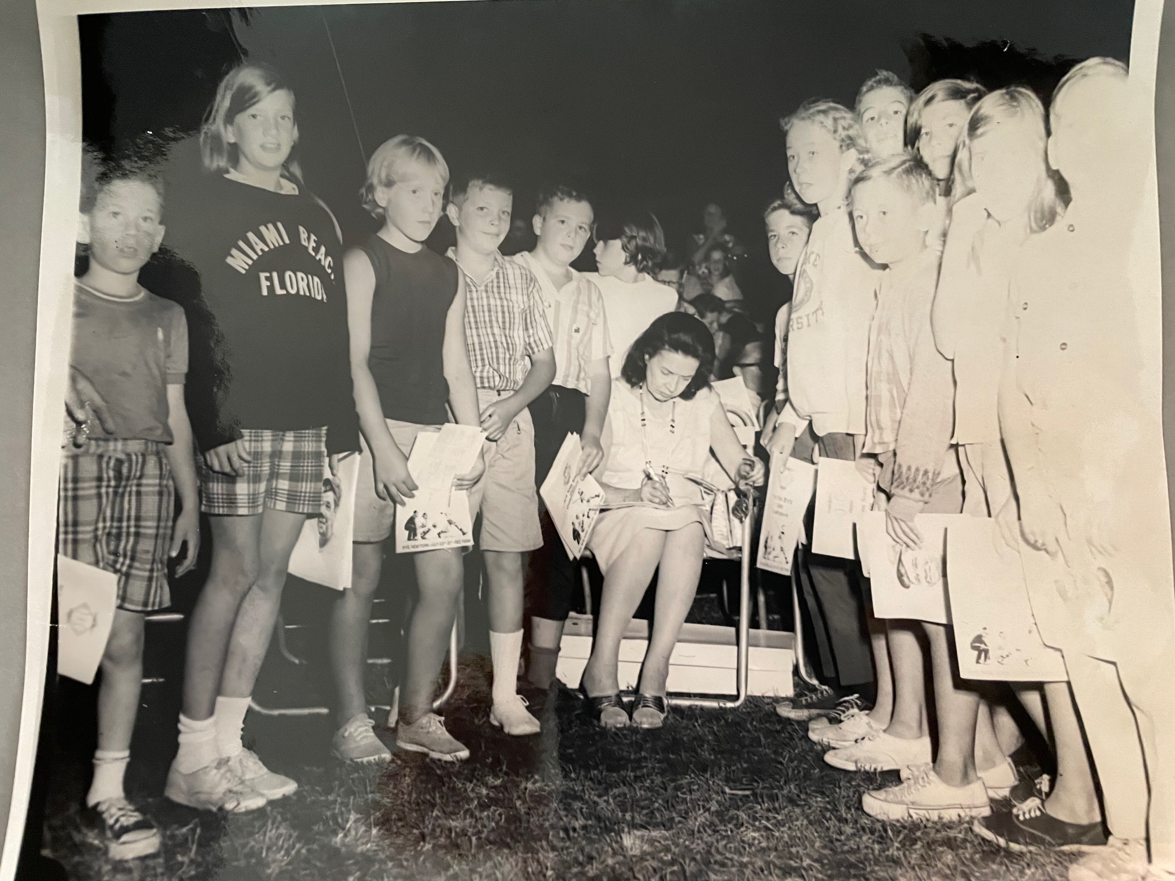 Claire Merritt Hodgson Ruth gives autographs to a group of children at the dedication of the Babe Ruth League in the late 1960s