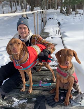 (PHOTO: Dr. Brian Alm, the new Rye City School District Assistant Superintendent for Human Resources and Leadership, with Blaise (8) and Luna (14 months), the family's Vizslas.)