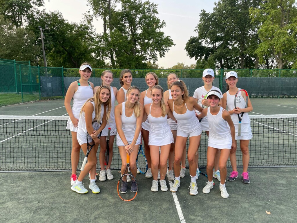 (PHOTO: The Rye Girls Varsity Tennis # 1 team poses for a photo in their tennis whites after practice at Manursing Island Club.)