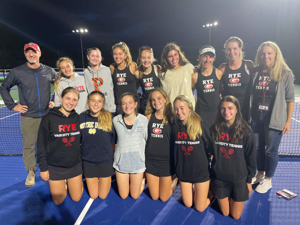 (PHOTO: The Rye Girls Varsity Tennis team and coaches celebrate their league title on the beautiful new Harrison tennis facility.)