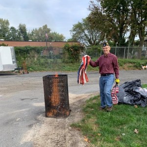 (PHOTO: Legionnaire de Barros retiring the first of over 400 flags.)