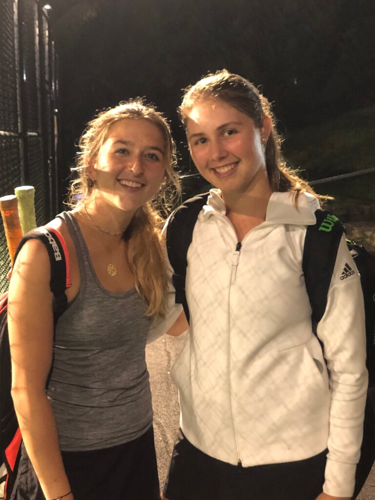 (PHOTO: Rye's #1 seeded doubles team of senior captains Juliette Stone and Charlotte Ausfahl smile in celebration following their semifinal victory at the Sectional tournament qualifying them for States.)