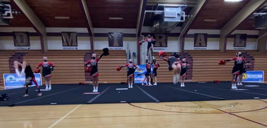 (PHOTO: Rye Girls Varsity Cheerleaders flipping out... at the Regional Game Day Championship on October 30, 2021 at Arlington High School.)