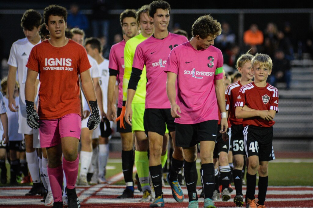 (PHOTO: Rye Boys Varsity Soccer MVP senior Jack Formon leading Rye Youth Soccer players during a pre-match walkout.)