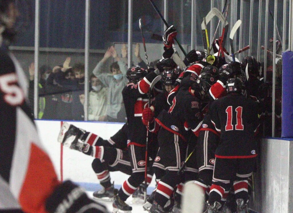 (PHOTO: Rye Boys Varsity Hockey celebrates its 4-3 OT win over Mamaroneck on Friday, December 3, 2021.)