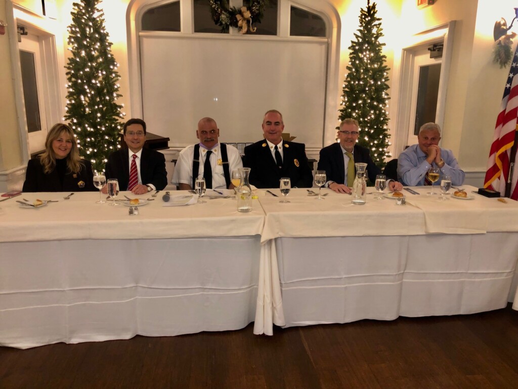 (PHOTO: Assembled at the 2021 Inspection Dinner to honor the Life Saving Award winners were Rye Fire Department chaplain Andrea Raynor, Rye Mayor Josh Cohn, Volunteer Chief Danny Bochicchio, Captain John McDwyer, City Manager Greg Usry and Director of Public Safety Mike Kopy.)