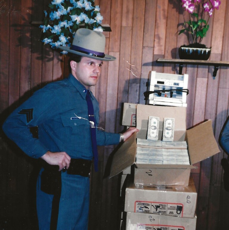 (PHOTO: The six million dollar man. New York State Trooper Kopy standing next to over $6 million dollars in 1992. The cash was seized from a home as part of a money laundering case.)