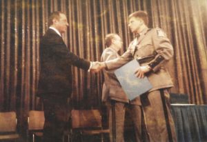 (PHOTO: New York Governor Mario Cuomo congratulating Kopy at his state trooper graduation in 1987.)
