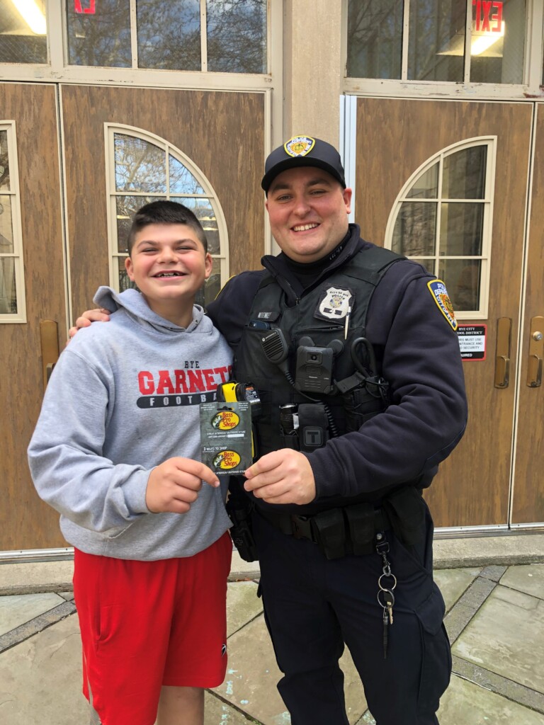 (PHOTO Rye Middle School student Jack Anderson with Police Officer Justin Keeney as Keeney awards Anderson a $25 gift card to Bass Pro shops.)