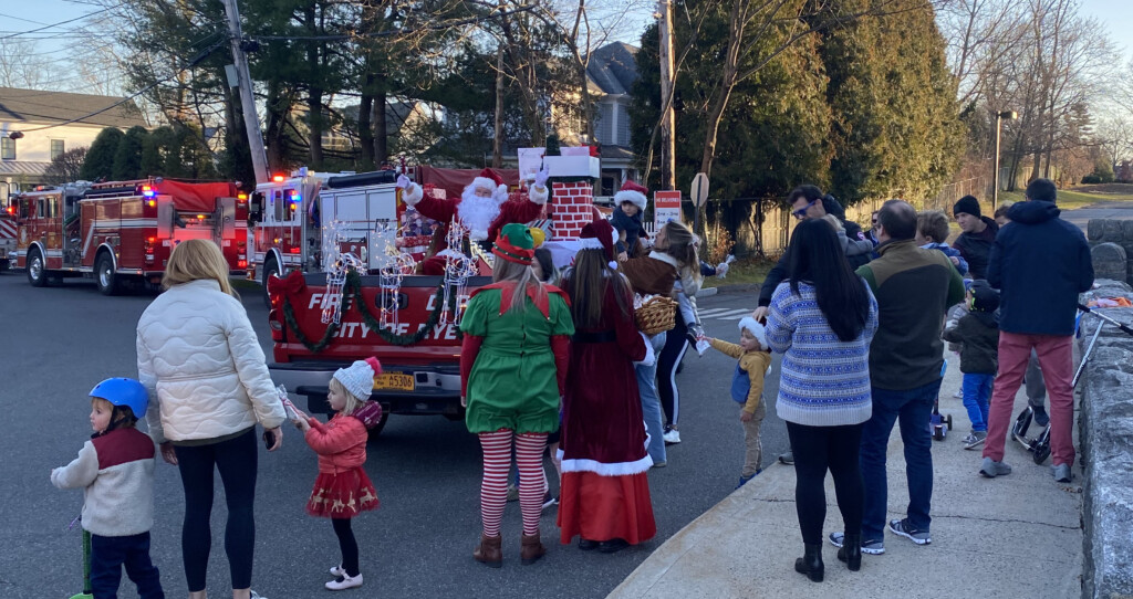 (PHOTO: Santa was able to leave his sleigh at home and catch a ride in a Rye FD pickup truck for the annual candy cane run.)