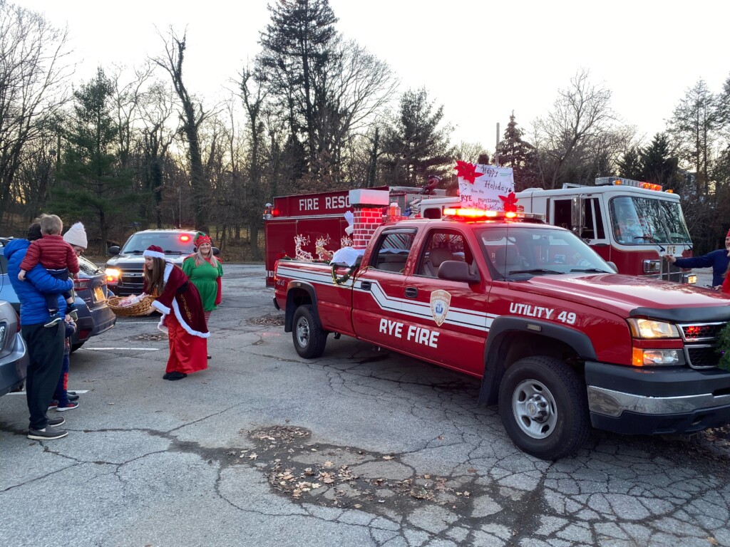 (PHOTO: Ms. Claus hands out candy canes on Sunday.)