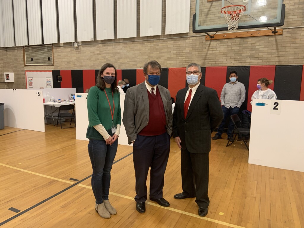 (PHOTO: Rye guy and County boss George Latimer stopped by the Westchester County Vaccine clinic at Rye Middle School on November 19th. He is pictured here with Board of Education President Jennifer Boyle (on left) and Heriberto Contreras, Sr., Coordinator of Community Outreach and Engagement for the Westchester County Department of Health (on right).)  