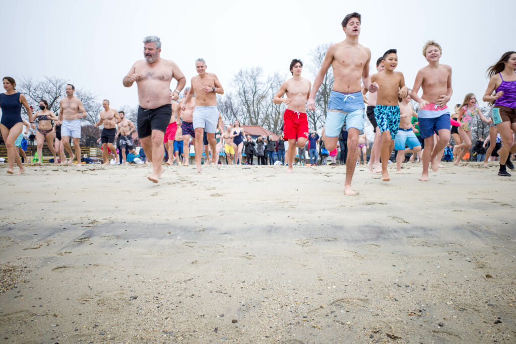 (PHOTO: The 20th Annual Ray’s Polar Bear Plunge on New Year's Day 2022 at Rye Town Park. Credit: Ed Szamborski.)