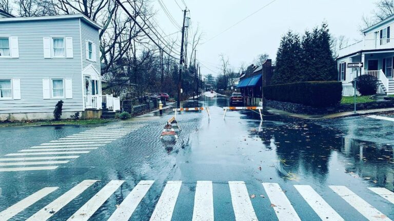 (PHOTO: Flooding from winter storm Izzy on Milton Road looking from the boat basin towards Oakland Beach Avenue.)