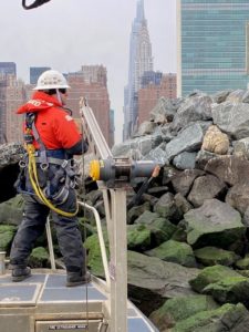 (PHOTO: Senior Chief Petty Officer Joey Bucciero of the USCG working on the agency's 26 foot Trailerable Aids to Navigation Boat (TANB) on the East River. This is the same boat the Coast Guard uses to service Milton Harbor.)