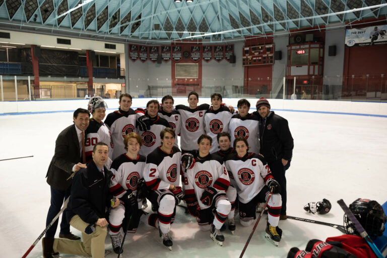 (PHOTO: Rye Boys Varsity Hockey's 12 seniors celebrate the 6-1 win over Scarsdale on Wednesday.)