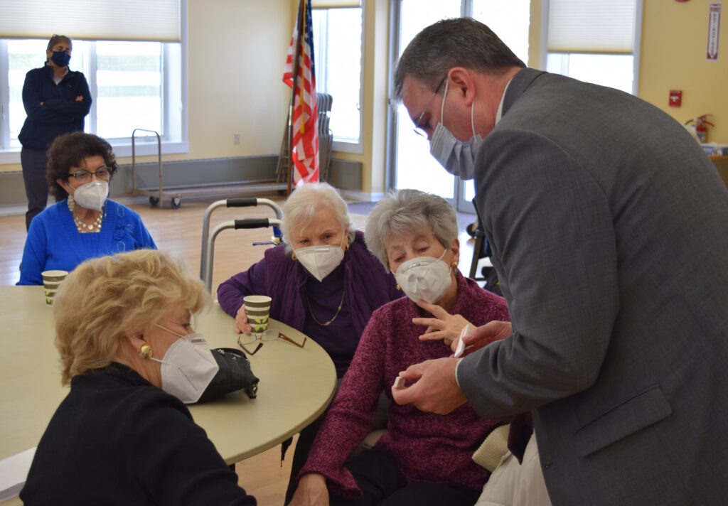 (PHOTO: Rye City School District's Superintendent Eric Byrne shows seniors how to read COVID-19 test results while Rye Rec Superintendent monitors the demonstration in the background.)