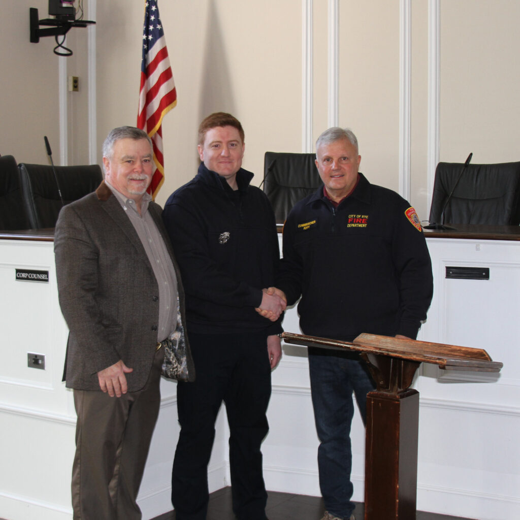 (PHOTO: New Rye Fire Fighter Andrew Wood with other Rye FD members at Rye City Hall on Friday, March 4, 2022.)