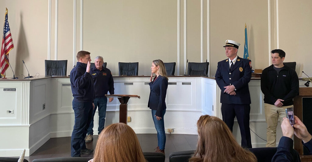 (PHOTO: New Rye Fire Fighter Andrew Wood is sworn in by City Clerk Carolyn D'Andrea, Esq. at Rye City Hall on Friday, March 4, 2022. Public Safety Commissioner Michael Kopy, Captain John McDwyer and new Assistant City Manager Brian Shea look on.)