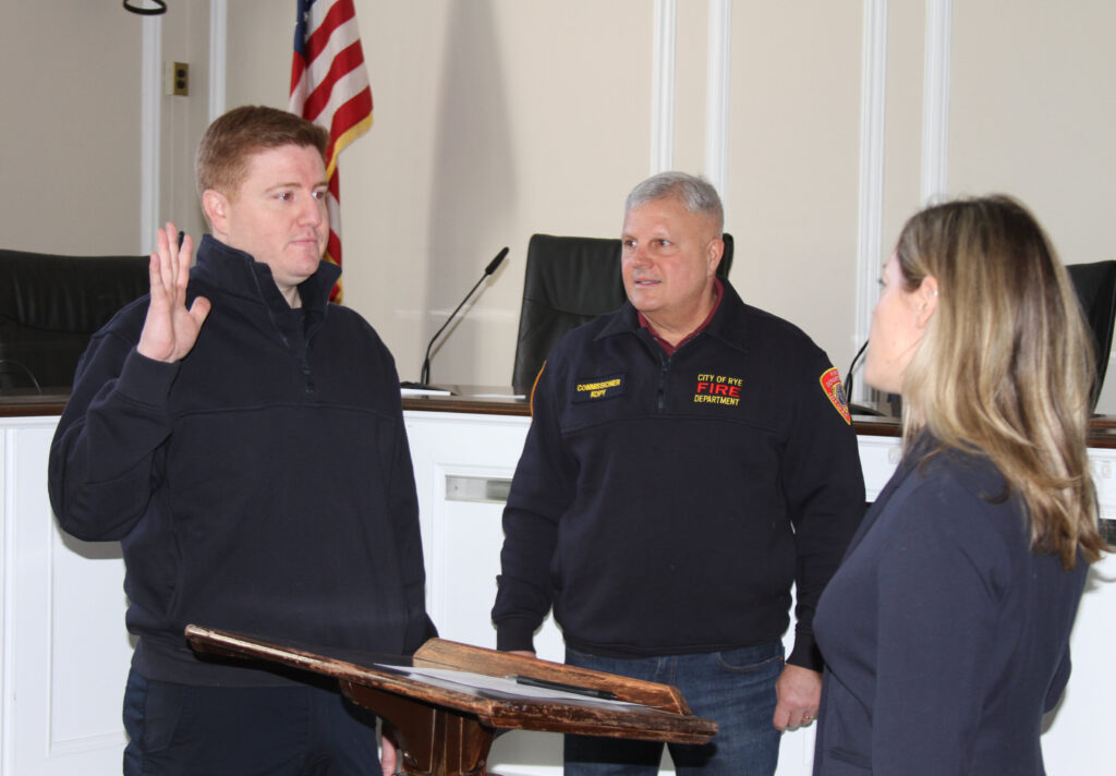 (PHOTO: New Rye Fire Fighter Andrew Wood is sworn in by City Clerk Carolyn D'Andrea, Esq. at Rye City Hall on Friday, March 4, 2022.)