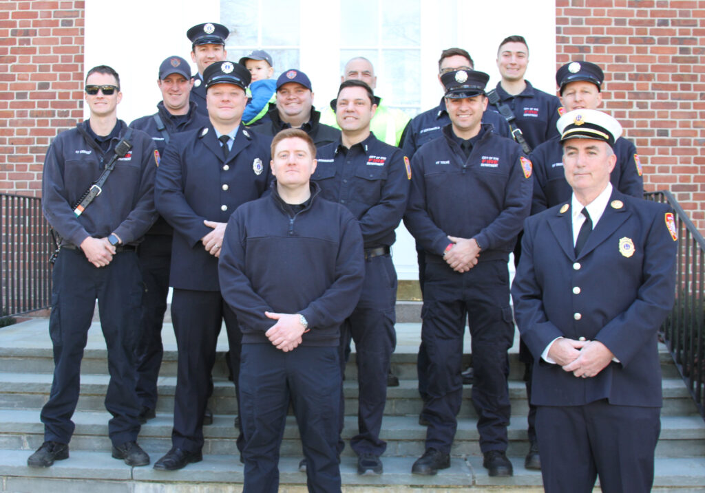 (PHOTO: New Rye Fire Fighter Andrew Wood with other Rye FD members at Rye City Hall on Friday, March 4, 2022.)