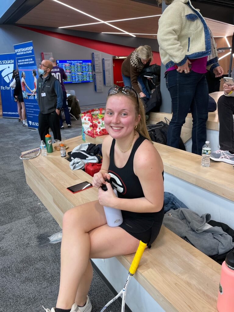 (PHOTO: Rye Senior Co-Captain Lente Smits gets some water after winning her match against Berkshire school in the quarterfinals of high school squash Nationals at UPenn.)