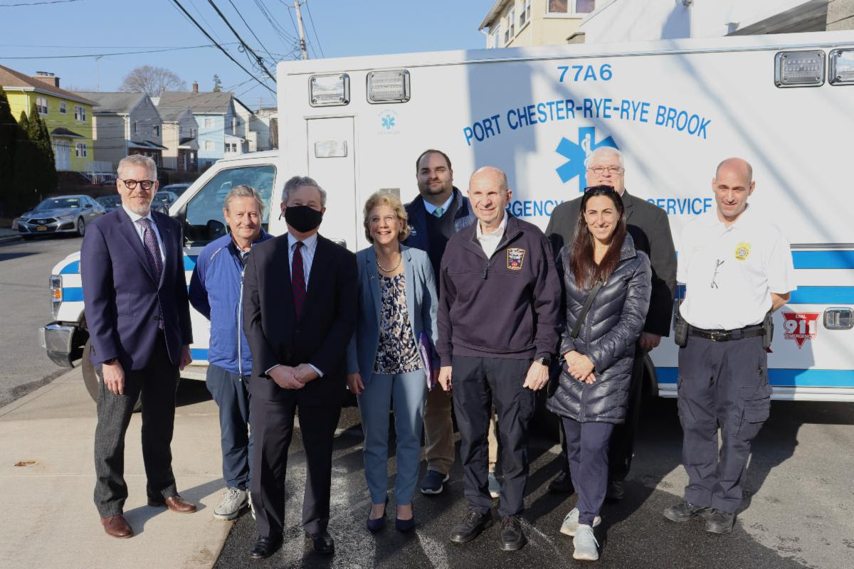 (PHOTO: Standing in front of Port Chester - Rye - Rye Brook EMS Rye City Manager Greg Usry, Rye City Councilman Bill Henderson, State Assemblyman Steve Otis, State Senator Shelley Mayer, Port Chester Village Manager Stuart Rabin, Rye Brook Trustee Stephanie Fischer, Rye Brook Village Administrator Chris Bradbury, County Department of Emergency Services Commissioner Richard Wishnie, PC-Rye-Rye Brook EMS Administrator Kenny Barton.)