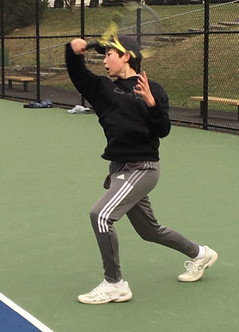 (PHOTO: Freshman and Rye Boys Varsity Tennis player Henry Gates gearing up for his first varsity season.)