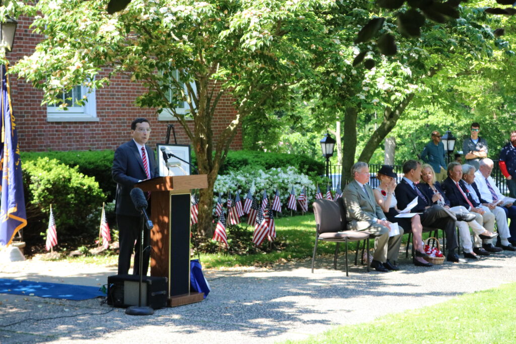 (PHOTO: Rye Mayor Josh Cohn speaking at the Memorial Day ceremony. Credit: Lainey Noga.)