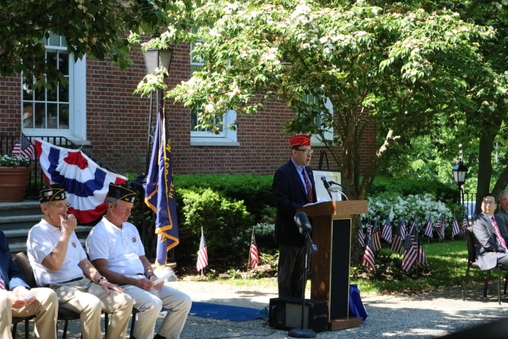 (PHOTO: US Marine Corps Veteran and Director of the Westchester Department of Consumer Protection Jim Maisano delivered the Memorial Day principal address. Credit: Lainey Noga.)
