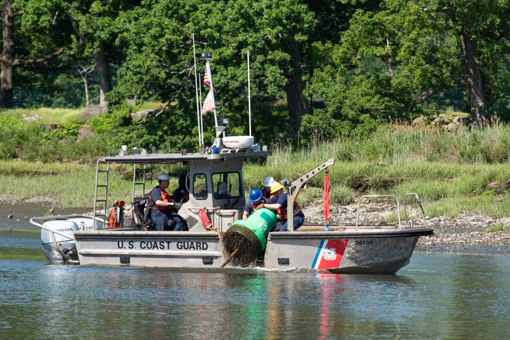 (PHOTO: A Coast Guard Aids to Navigation Team (ANT) New York boat crew temporarily disestablishes buoys from Milton Harbor, New York, June 6, 2022. Due to significant shoaling in the area, the depth of water has become too shallow for Coast Guard crews to regularly access and service the buoys. Private aids to navigation will mark the channel until dredging is complete. Credit: U.S. Coast Guard photo by Petty Officer 3rd Class Ryan Schultz)