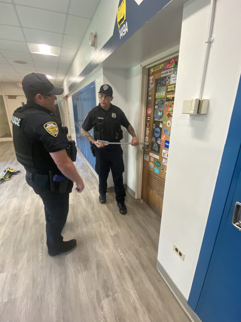 (PHOTO: Rye PD officers discuss best ways to breach a door during active shooter training on the Rye High School and Middle School campus on Sunday, June 26, 2022. 2- 1/8)