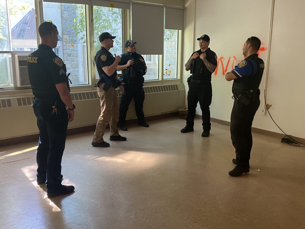 (PHOTO: Rye PD officers discuss their response during active shooter training on the Rye High School and Middle School campus on Sunday, June 26, 2022. 2- 7/8)