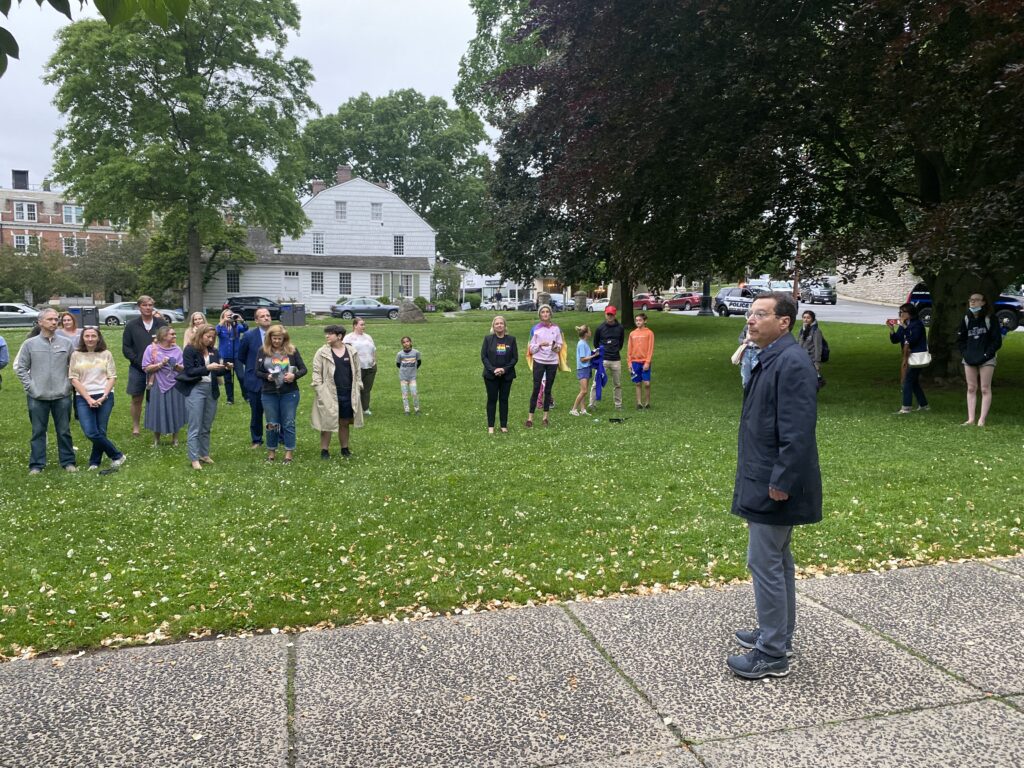 (PHOTO: Rye Mayor Josh Cohn addresses the crowd at the 2nd Annual Pride flag raising.)