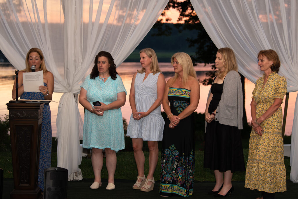 (PHOTO: Wainwright Board Member Staci Ramachandran with summer gala honorees from the The Rye Relief Team for Hurricane Ida: Kendra Moran, Laura Pellegrini, Stephanie Gomez, Colleen Margiloff and Cliona Cronin. Not pictured: Lynn Halpern. Credit: Jo Bryan.)