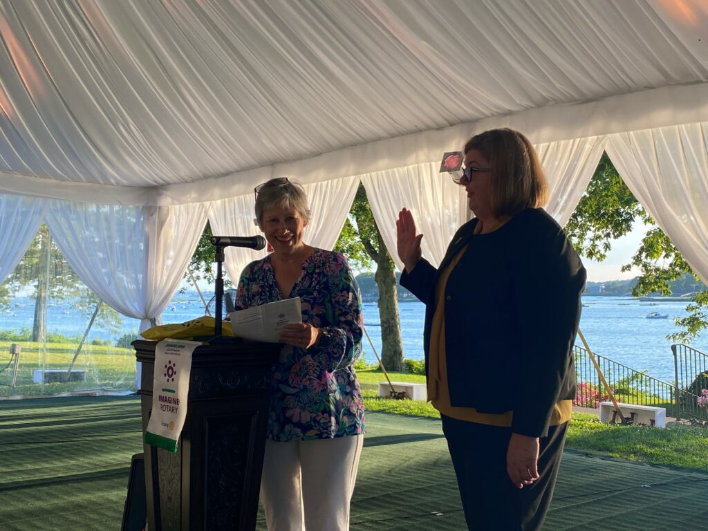 (PHOTO: Lora Hugelmeyer, Rye Rotary member and former Rotary district governor swears in Michele Thomas as Rye Rotary president for 2022-23 during a June 29, 2022 ceremony at Wainwright House.)