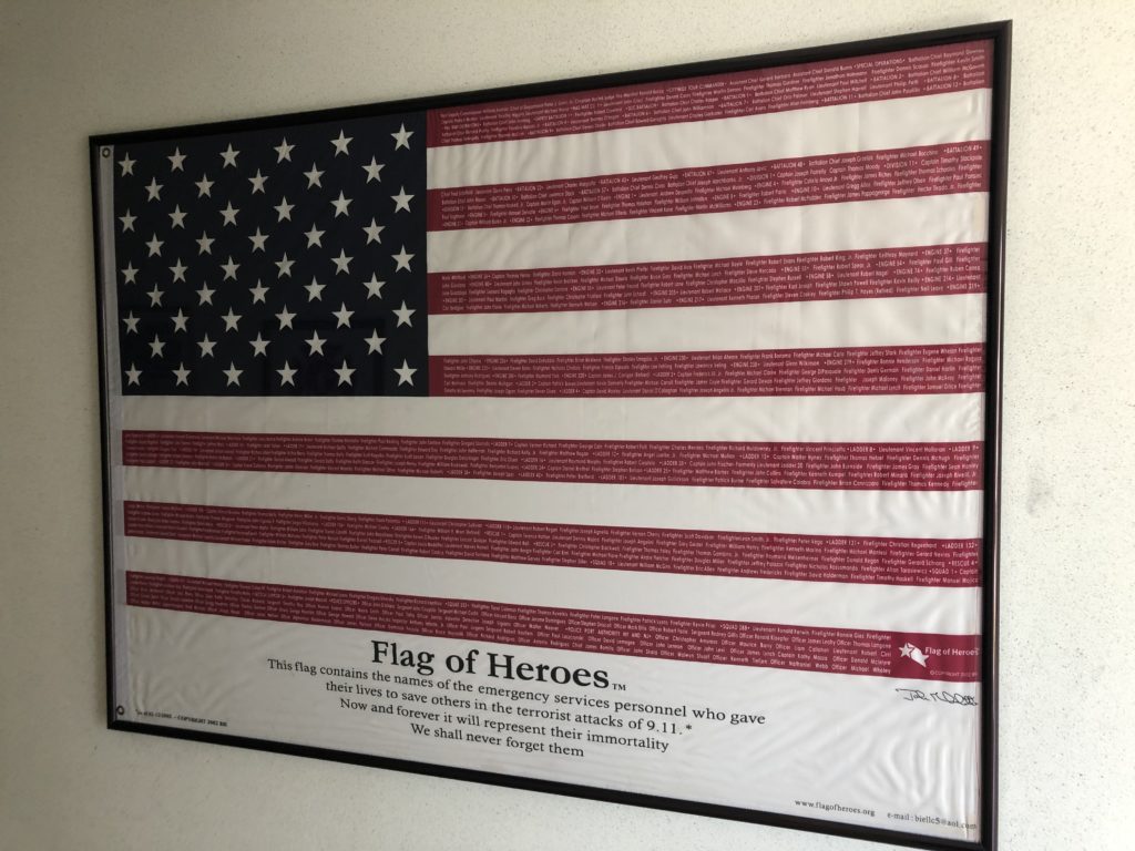 (PHOTO: The Flag of Heroes, as displayed at Rye FD headquarters in 2021. Credit: Will McCullough.)