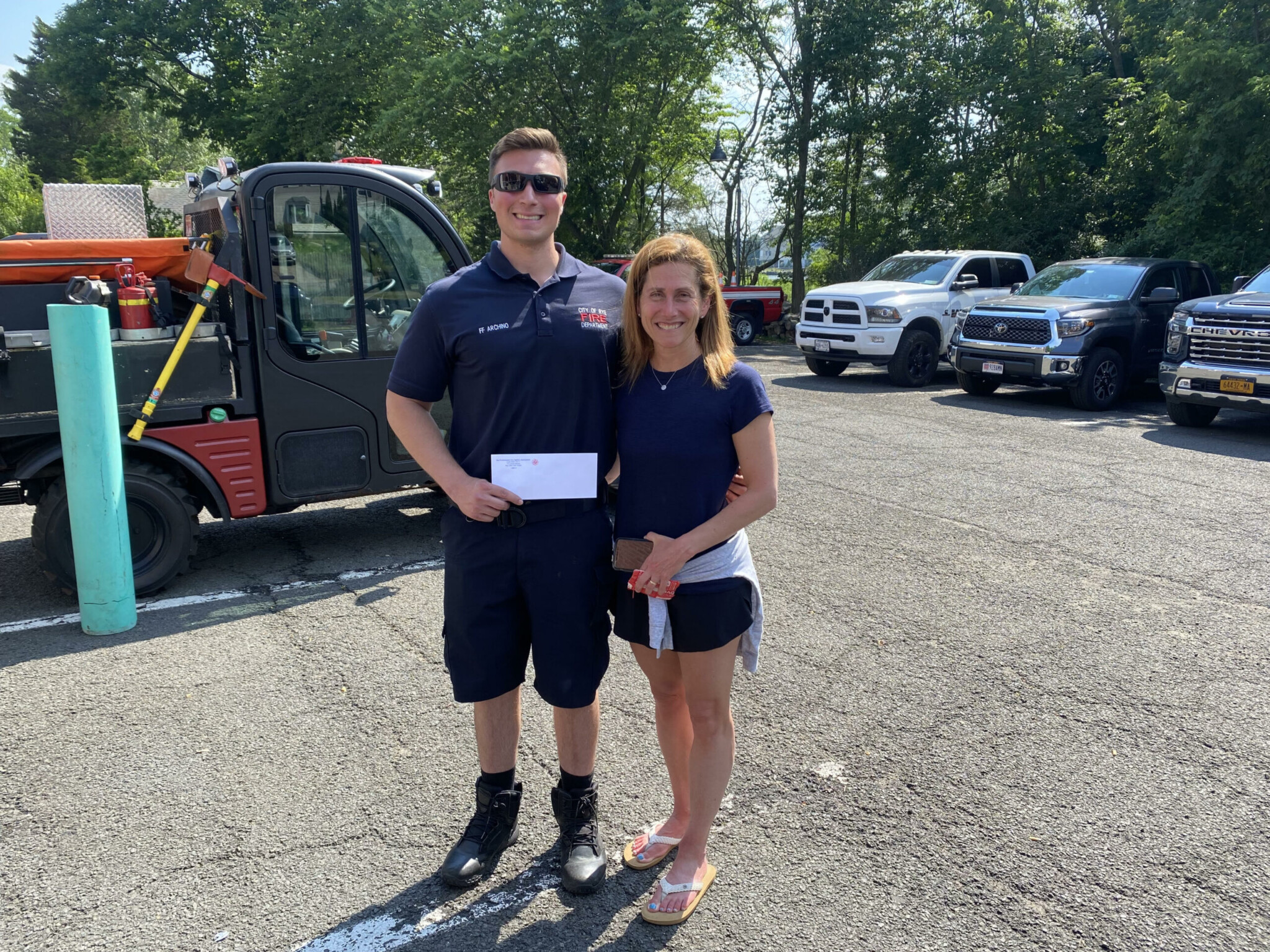 (PHOTO: Rye FD Local 2029 member Danny Archino presents a $4,000 donation to SoulRyeders founder Sandy Samberg.)