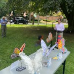 (PHOTO: Mayor Josh Cohn talks about the benefits of the oversized pollinators.)