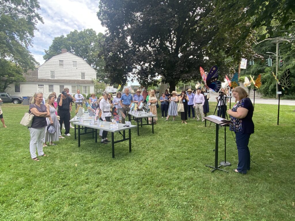 (PHOTO: Westchester County Legislator Catherine Parker, far left in photo, looks on at the Rye'sAbove Butterfly unveiling on the Village Green.)