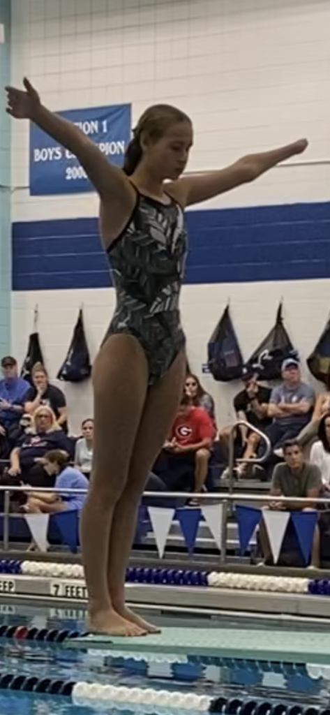 (PHOTO: Rye Girls Varsity Swimming & Diving team member Kaitlyn Bentley preparing to dive.)