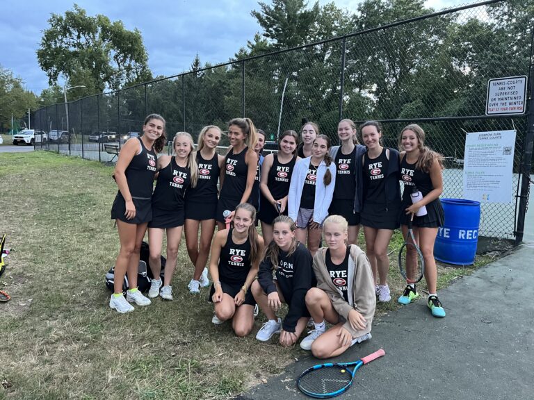 (PHOTO: The Rye Girls Varsity Tennis team poses for a team photo after a hard fought match against League champion favorite Harrison on Wednesday.)