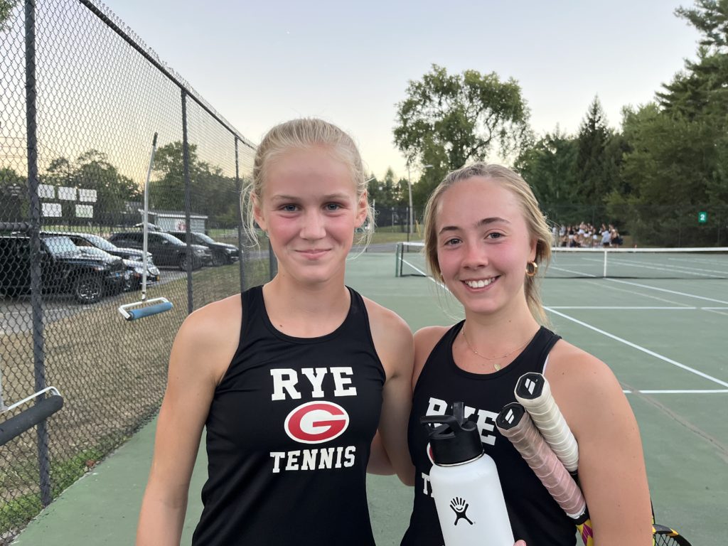 (PHOTO: Rye Girls Varsity Tennis players Ella Poole and Ryan Wade fresh off their big win against Mamaroneck on Thursday to open the season.)