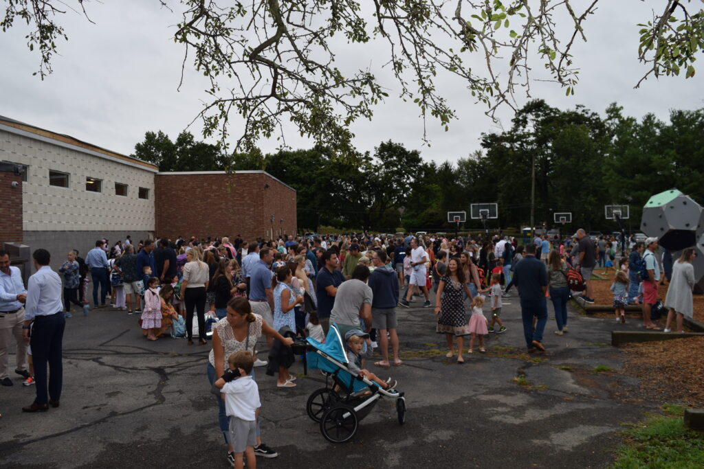 (PHOTO: Exciting times as families bring students back for the first day at the Osborn Elementary School.)