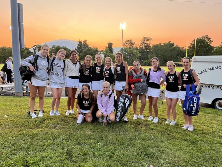 (PHOTO: After strolling through the Pelham football crowd Rye Girls Varsity Tennis poses for a post victory photo on Friday.)