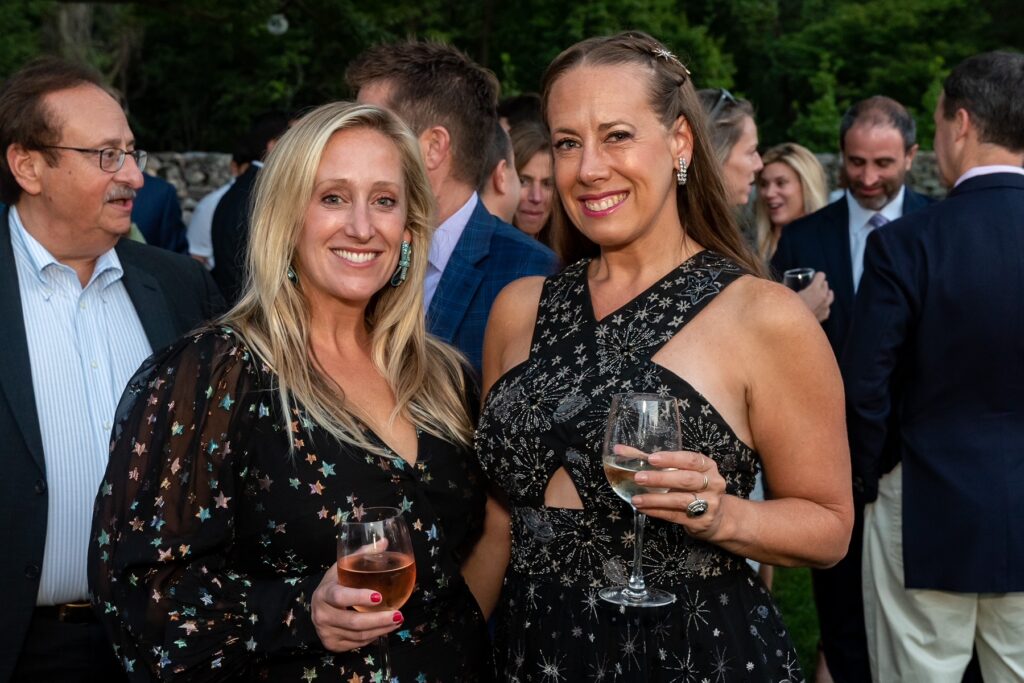 (PHOTO: Alexis Scahill and Julie Fabricant mingle with guests and native plants at the Jay Heritage Center’s 30th Anniversary Moonlight Soirée on September 17, 2022.)