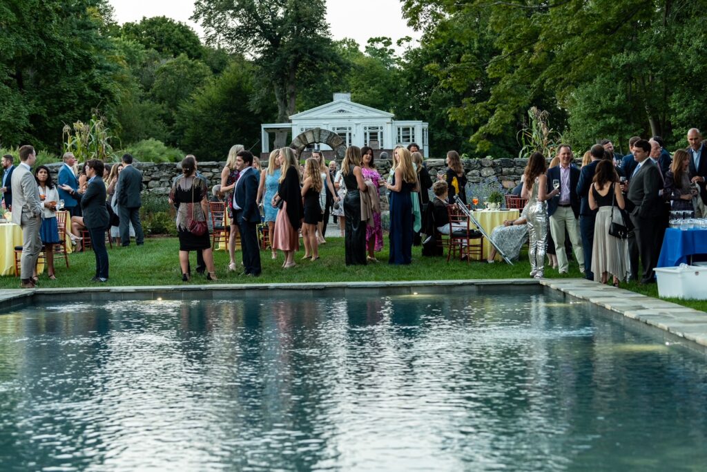 (PHOTO: Guests enjoy drinks by the Jay garden reflecting pool at the 30th Anniversary Moonlight Soirée on September 17, 2022.)