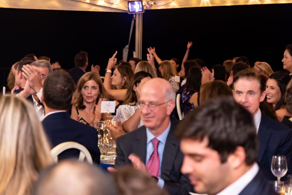 (PHOTO: Hands up! Exercising auction muscles at the Jay Heritage Center’s 30th Anniversary Moonlight Soirée on September 17, 2022.)